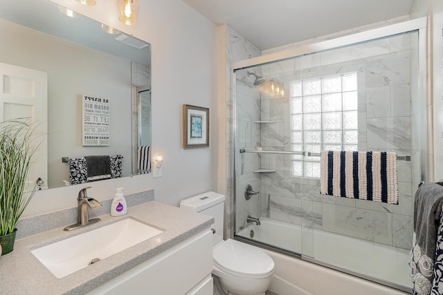 full bathroom featuring toilet, vanity, and shower / bath combination with glass door