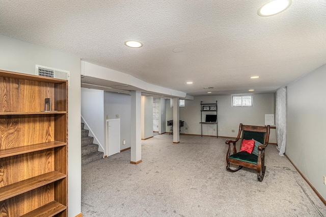 basement with light carpet and a textured ceiling