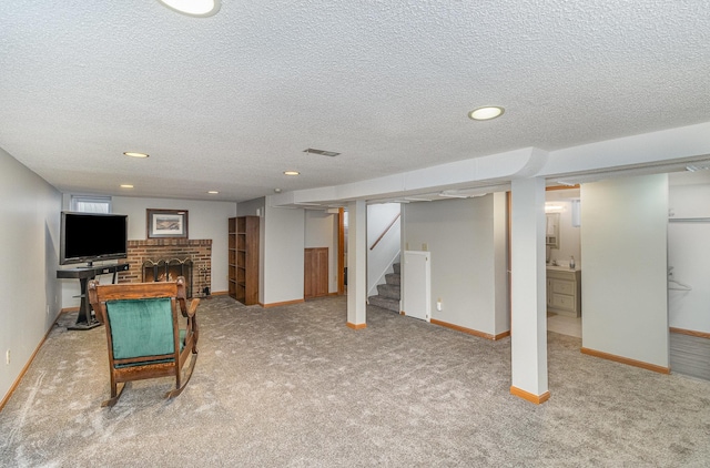 rec room with a brick fireplace, a textured ceiling, and carpet flooring