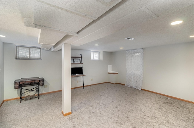 basement with light carpet and a textured ceiling