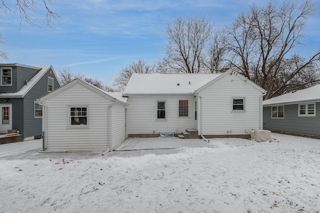 view of snow covered back of property