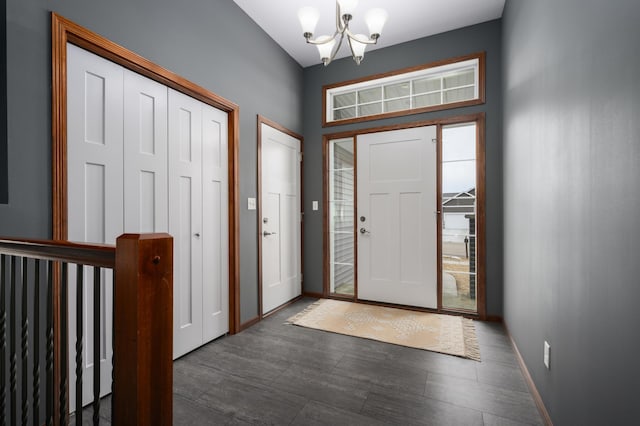 entrance foyer with baseboards and a notable chandelier