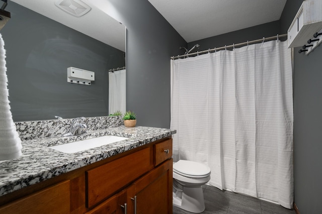 bathroom with visible vents, vanity, and toilet