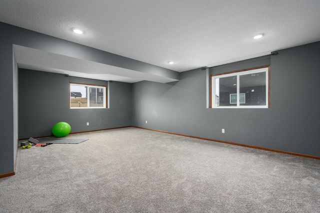 workout area featuring carpet, a textured ceiling, baseboards, and recessed lighting