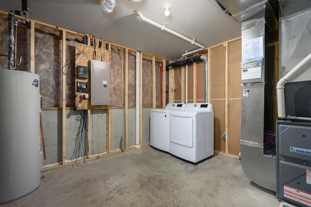 unfinished basement with water heater, independent washer and dryer, electric panel, and heating unit