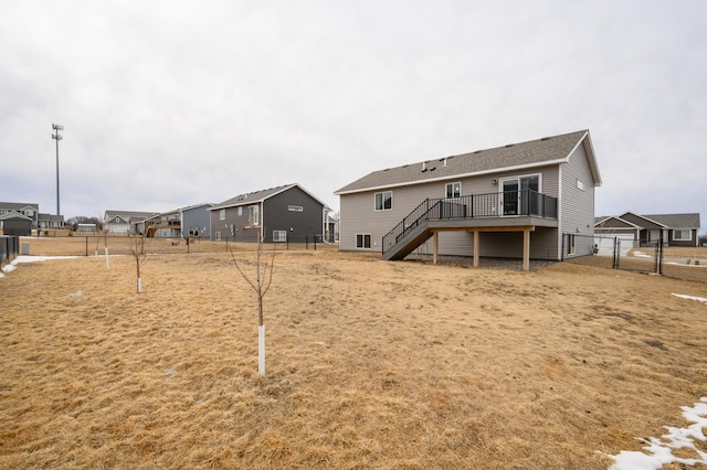 back of house with a residential view, fence, a deck, and stairs