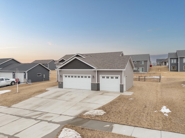 view of front of home with concrete driveway, brick siding, roof with shingles, and a residential view