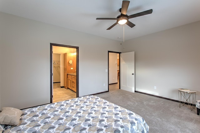 bedroom with connected bathroom, ceiling fan, and light colored carpet