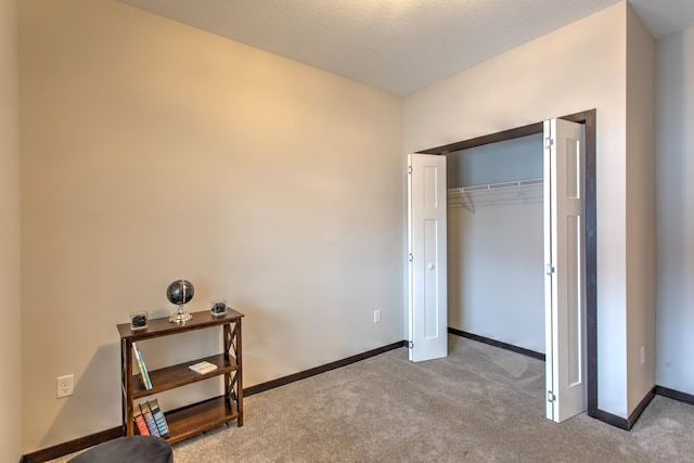 bedroom featuring a closet and light carpet