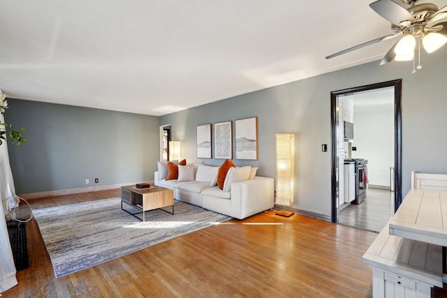 unfurnished living room with ceiling fan and light hardwood / wood-style floors