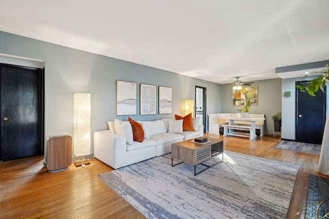 living room with hardwood / wood-style floors and ceiling fan