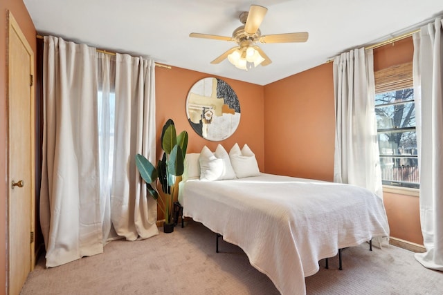 bedroom featuring light colored carpet and ceiling fan