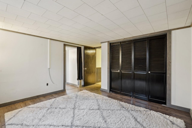 unfurnished bedroom with dark wood-type flooring