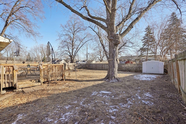 view of yard featuring a deck and a storage unit