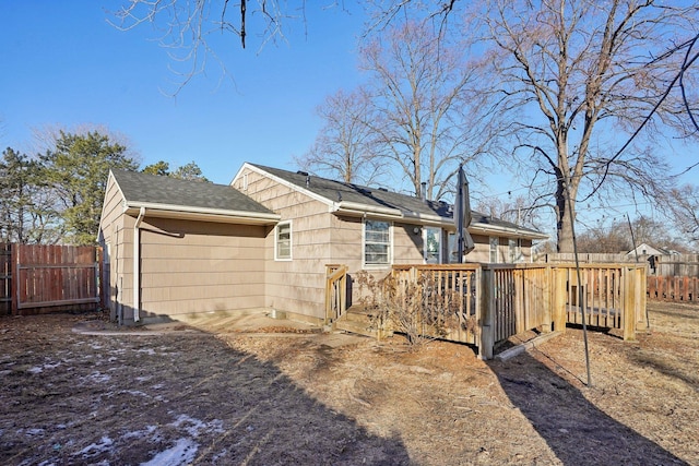 back of house with a deck