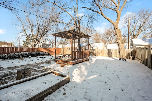 yard covered in snow featuring a pergola and a wooden deck