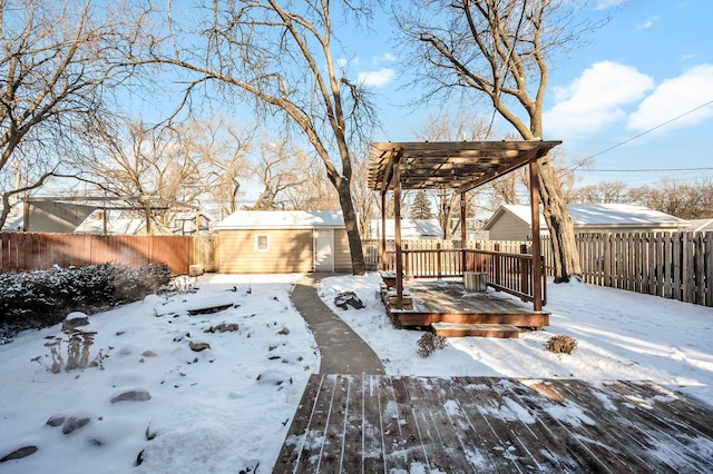 yard layered in snow with cooling unit, a deck, and a storage unit