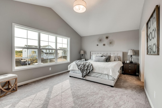 bedroom with carpet floors and vaulted ceiling