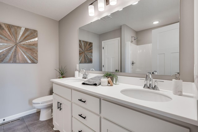 bathroom featuring a textured ceiling, tile patterned flooring, toilet, walk in shower, and vanity