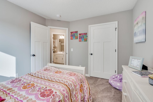 bedroom featuring a textured ceiling and light colored carpet