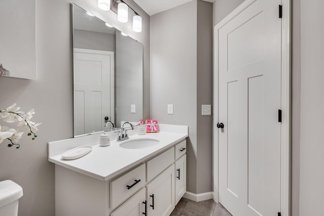 bathroom featuring toilet, vanity, and tile patterned floors