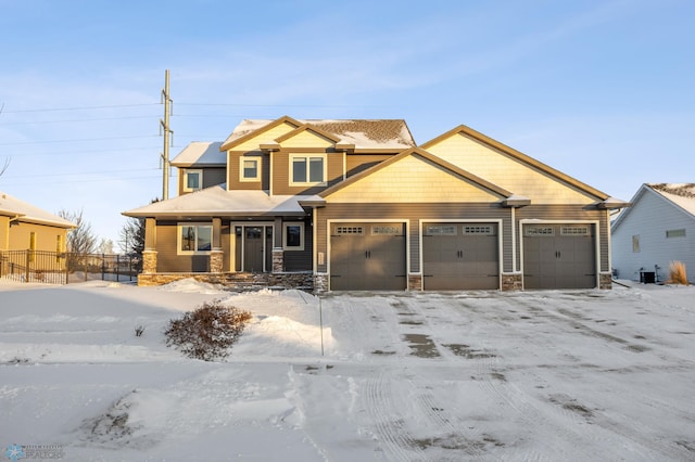 craftsman-style home with a garage and cooling unit