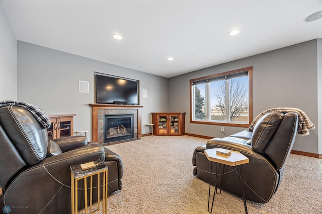 carpeted living room with a tiled fireplace