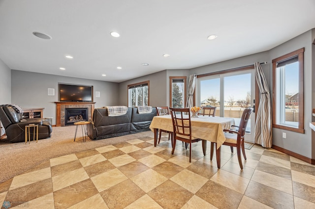 dining area with a tiled fireplace