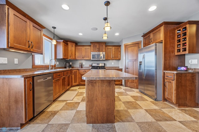 kitchen with sink, stainless steel appliances, a center island, and pendant lighting