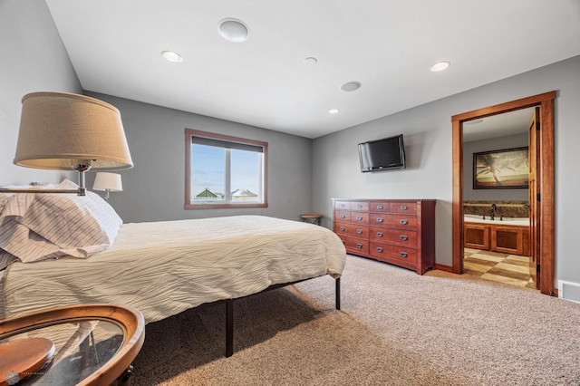 carpeted bedroom with ensuite bath