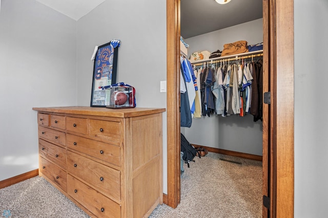 spacious closet featuring light colored carpet