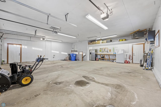 garage featuring a garage door opener and white refrigerator