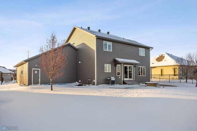 view of snow covered rear of property