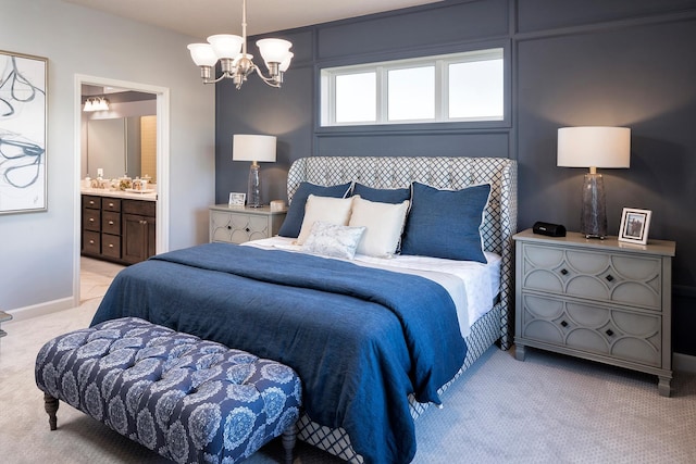 bedroom featuring light carpet, ensuite bath, and a chandelier