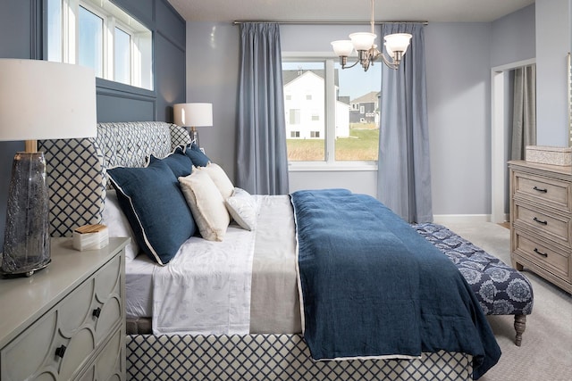 carpeted bedroom featuring a chandelier