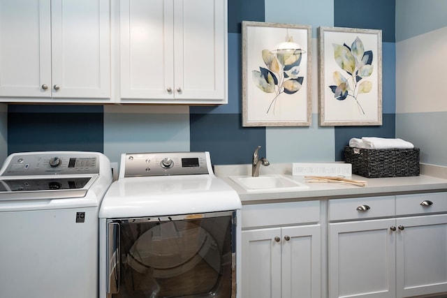 laundry area with washer and clothes dryer, sink, and cabinets