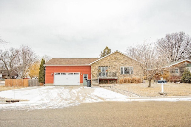 view of front of property featuring a garage and central AC