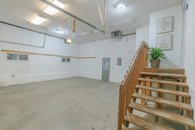 garage with a garage door opener and electric panel