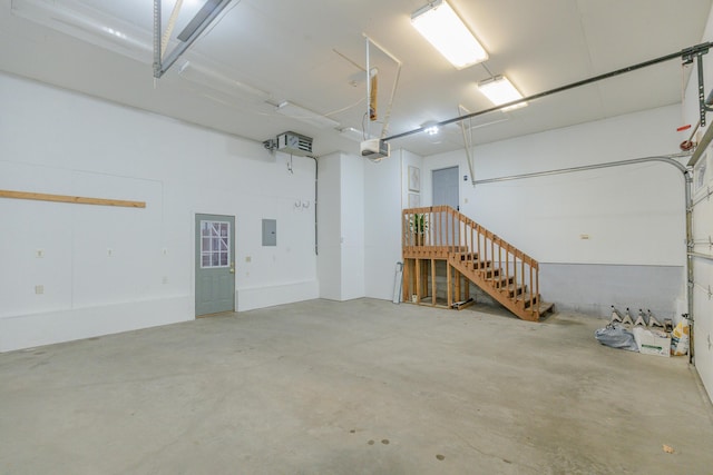 garage featuring a garage door opener and electric panel