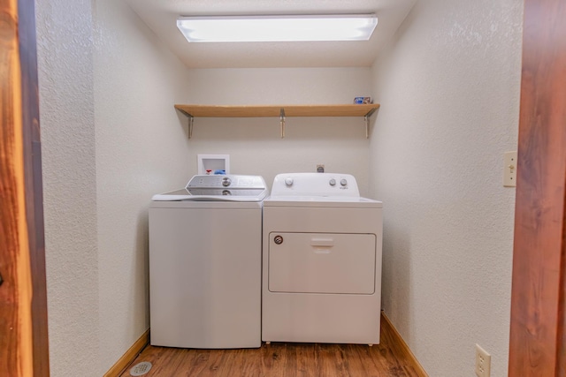 laundry area featuring separate washer and dryer and light wood-type flooring