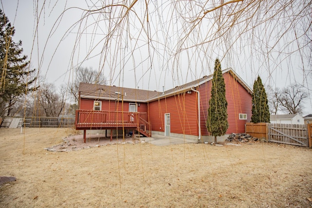 back of house with a wooden deck