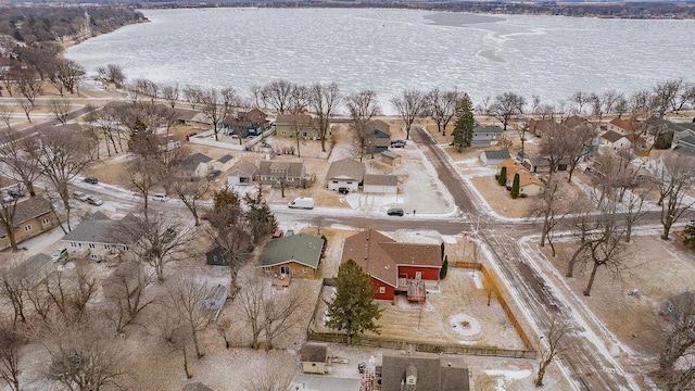 snowy aerial view featuring a water view