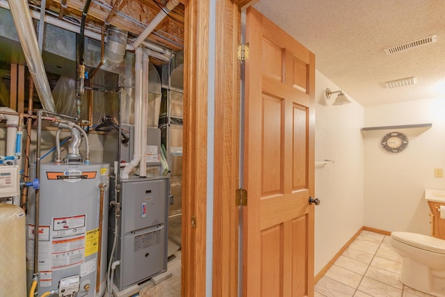 utility room featuring water heater