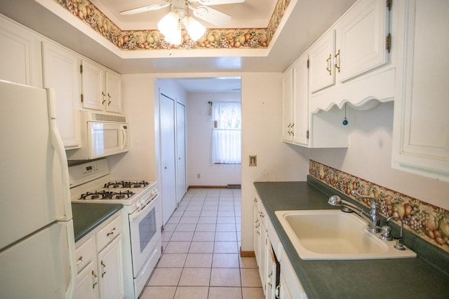 kitchen featuring sink, white appliances, light tile patterned floors, and white cabinets