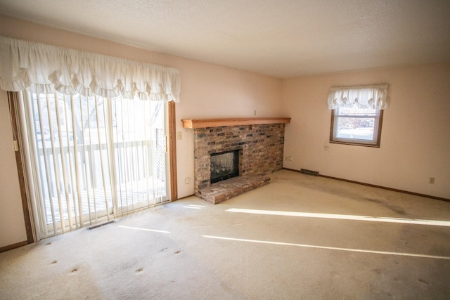 unfurnished living room featuring carpet floors and a fireplace