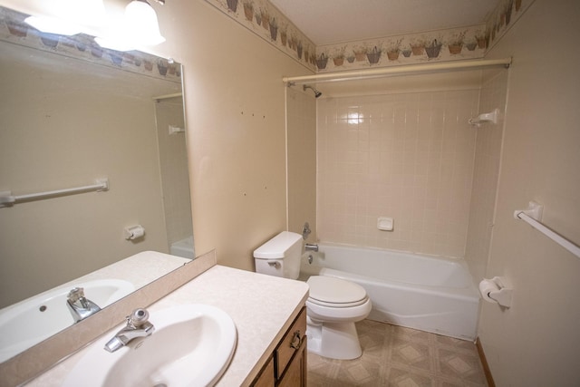 full bathroom featuring toilet, tiled shower / bath, and vanity