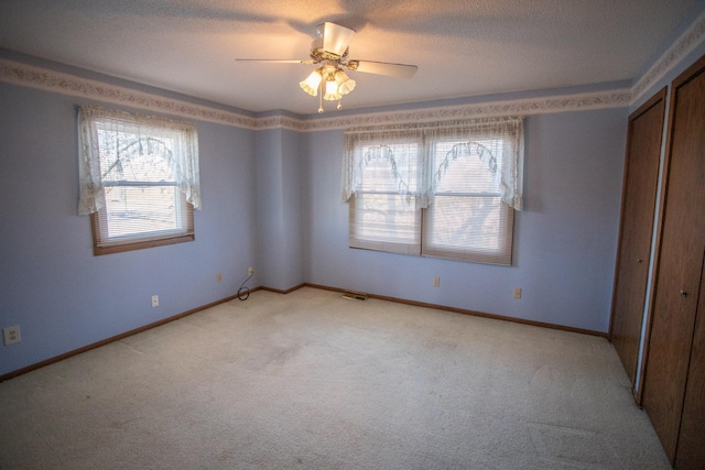 unfurnished bedroom featuring a closet, ceiling fan, and light colored carpet