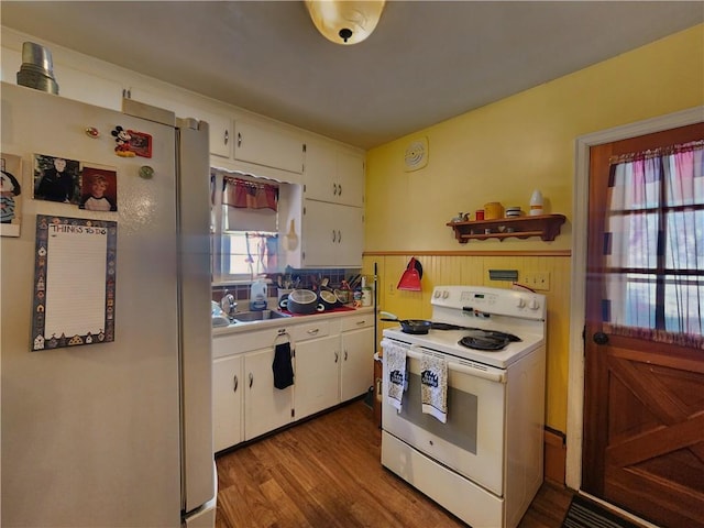 kitchen featuring white appliances, white cabinets, light wood-type flooring, and sink