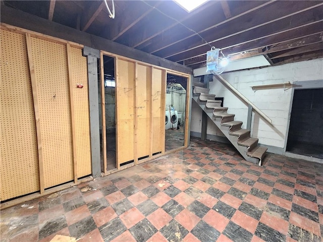 unfinished basement with stairs and washing machine and dryer