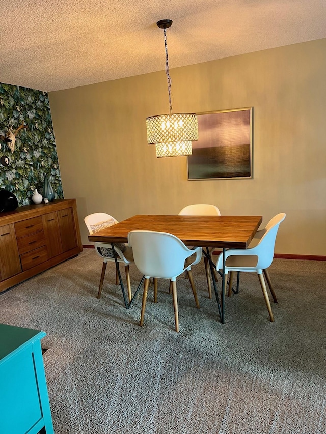 carpeted dining space with a textured ceiling